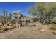 Stunning desert landscape surrounds this two-story home with a large stone driveway at 3110 Arroyo Hondo --, Carefree, AZ 85377