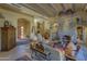 Spacious living room with a stone fireplace, high ceilings, and large windows at 3110 Arroyo Hondo --, Carefree, AZ 85377