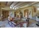 Open concept living room with a large stone fireplace and high ceilings at 3110 Arroyo Hondo --, Carefree, AZ 85377