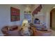 Cozy living room with fireplace, leather chairs, and southwestern-style decor at 3110 Arroyo Hondo --, Carefree, AZ 85377