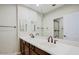 Double vanity bathroom with dark wood cabinets and large mirror at 3935 E Rough Rider Rd # 1101, Phoenix, AZ 85050