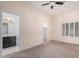 Spacious bedroom with carpet flooring, access to bathroom, and large window with shutters at 6720 E Encanto St # 61, Mesa, AZ 85205