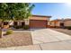 Single-story home with a two-car garage and desert landscaping at 6720 E Encanto St # 61, Mesa, AZ 85205