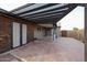 Covered patio with wooden pergola and storage shed at 723 W 5Th Ave, Apache Junction, AZ 85120