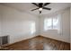 Spacious bedroom with wood floors and ceiling fan at 723 W 5Th Ave, Apache Junction, AZ 85120