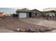 Front view of a single-story house with a curved driveway at 723 W 5Th Ave, Apache Junction, AZ 85120