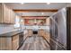 L-shaped kitchen with brick backsplash and wood cabinets at 723 W 5Th Ave, Apache Junction, AZ 85120