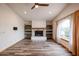 Living room features a brick fireplace and wood-look floors at 723 W 5Th Ave, Apache Junction, AZ 85120