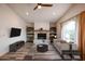 Spacious living room with a brick fireplace and wood-look floors at 723 W 5Th Ave, Apache Junction, AZ 85120