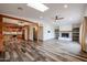 Open concept living and kitchen with wood-look floors and a fireplace at 723 W 5Th Ave, Apache Junction, AZ 85120