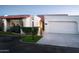 Spanish style home with tile roof, white stucco, and a two car garage at 7331 E Valley Vista Dr, Scottsdale, AZ 85250