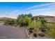 Two-story house with desert landscaping and driveway at 8595 E Bronco Trl, Scottsdale, AZ 85255