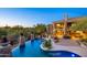 Luxury house with a large pool and desert landscape at 8595 E Bronco Trl, Scottsdale, AZ 85255