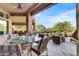 Covered patio with outdoor seating and a view of the pool at 9378 E Sundance Trl, Scottsdale, AZ 85262