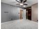 Bedroom with carpet, ceiling fan, and built-in shelving at 965 N 87Th Way, Scottsdale, AZ 85257