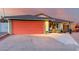 Ranch style home with orange garage door and landscaped yard at 965 N 87Th Way, Scottsdale, AZ 85257