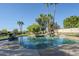 Inviting pool with a waterfall feature, surrounded by lush landscaping and stone accents at 9948 N 119Th Pl, Scottsdale, AZ 85259