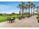 Outdoor patio with tables and chairs, lush landscaping at 12388 W Fetlock Trl, Peoria, AZ 85383