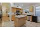 Bright kitchen with island, stainless steel appliances, and light wood cabinets at 15881 W Moreland W St, Goodyear, AZ 85338