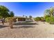 Spacious backyard with gravel, desert landscaping, and partial house view at 19607 N Signal Butte Cir, Sun City, AZ 85373