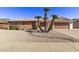 Brick ranch house with three palm trees and gravel landscaping at 19607 N Signal Butte Cir, Sun City, AZ 85373