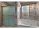 Bathroom features a large tub, shower, and updated tilework at 2606 N 89Th Dr, Phoenix, AZ 85037