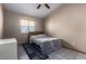 Bright bedroom with a double bed and ceiling fan at 2606 N 89Th Dr, Phoenix, AZ 85037