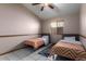 Bedroom with two twin beds and ceiling fan at 2606 N 89Th Dr, Phoenix, AZ 85037