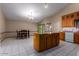 Kitchen boasts an island, granite countertops, and ample wood cabinets at 2606 N 89Th Dr, Phoenix, AZ 85037