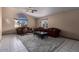 Spacious living room with tiled floors, large windows, and ample natural light at 2606 N 89Th Dr, Phoenix, AZ 85037