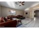 Bright living room with tiled floors, comfy furniture, and a ceiling fan at 2606 N 89Th Dr, Phoenix, AZ 85037