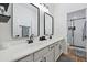 Modern bathroom with dual sinks, black accents, and a glass shower at 2811 E Riviera Pl, Chandler, AZ 85249