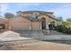 Two-story house with tan exterior, two-car garage, and landscaping at 2811 E Riviera Pl, Chandler, AZ 85249