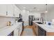 Modern kitchen with white cabinets, quartz countertops, and stainless steel appliances at 2811 E Riviera Pl, Chandler, AZ 85249