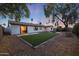 Spacious backyard with artificial turf and a fire pit area at 3502 E Janice Way, Phoenix, AZ 85032