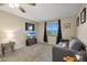 Cozy bedroom with grey couch and a window showcasing a view at 3502 E Janice Way, Phoenix, AZ 85032