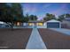 Cute single story home with a gray garage door and landscaped yard at 3502 E Janice Way, Phoenix, AZ 85032