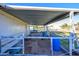 Covered animal pen with dirt floor and blue barrel at 5701 N 105Th Ln, Glendale, AZ 85307