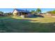 Landscaped backyard showcasing outdoor kitchen and patio at 5701 N 105Th Ln, Glendale, AZ 85307
