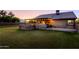 Landscaped backyard with covered patio and outdoor kitchen at 5701 N 105Th Ln, Glendale, AZ 85307