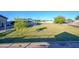 Large grassy backyard with storage sheds and a spacious area at 5701 N 105Th Ln, Glendale, AZ 85307