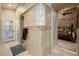 Bathroom with a walk-in shower, glass block feature, and neutral tile at 5701 N 105Th Ln, Glendale, AZ 85307
