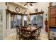 Cozy breakfast nook with a rustic wooden table and chairs, built in shelves and large windows at 5701 N 105Th Ln, Glendale, AZ 85307