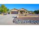 Front view of a single-story home with a two-car garage and rock landscaping at 5701 N 105Th Ln, Glendale, AZ 85307