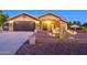 House exterior at dusk showcasing a well-maintained front yard and landscaping at 5701 N 105Th Ln, Glendale, AZ 85307