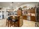 Spacious kitchen featuring rustic wooden cabinetry, a large island and stainless steel appliances at 5701 N 105Th Ln, Glendale, AZ 85307