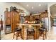 Rustic kitchen with ample cabinetry, an island, and stainless steel appliances at 5701 N 105Th Ln, Glendale, AZ 85307