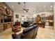 Open concept kitchen and living area with custom wooden cabinetry at 5701 N 105Th Ln, Glendale, AZ 85307