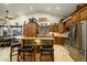 Open kitchen with custom wood cabinetry, granite countertops, and a large island at 5701 N 105Th Ln, Glendale, AZ 85307