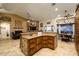 Open-concept kitchen with a large island and views into the living area at 5701 N 105Th Ln, Glendale, AZ 85307